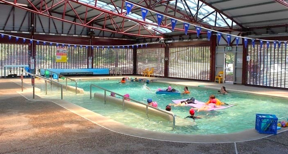 Another angle of the heated pool located inside Bribie Island Aquatic and Leisure Centre. The pool is quite large and can accommodate multiple guests at the same time. There are safety railings are modern and thoughtfully positioned to provide support to the guests. The area is covered with curved, corrugated iron roof lines, adding a unique touch to the overall look of the space. Another angle of the heated pool located inside Bribie Island Aquatic and Leisure Centre. The pool is quite large and can accommodate multiple guests at the same time. There are safety railings are modern and thoughtfully positioned to provide support to the guests. The area is covered with curved, corrugated iron roof lines, adding a unique touch to the overall look of the space.