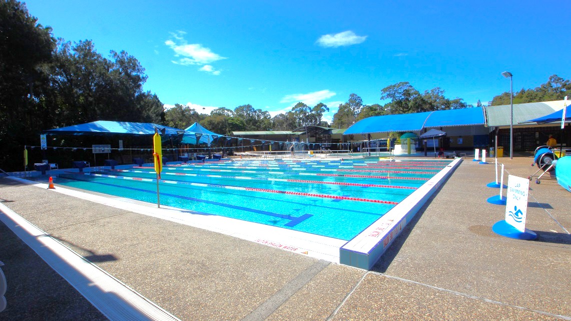 Another look at the expansive swimming pool inside the Bribie Island Aquatic and Leisure Centre. It's wide and perfect for lap swimming. There are signs reminding visitors that only lap swimming is allowed in this pool area. Surrounding the entire open-air aquatic area, you'll see tall trees, adding a natural and refreshing ambiance. Another look at the expansive swimming pool inside the Bribie Island Aquatic and Leisure Centre. It's wide and perfect for lap swimming. There are signs reminding visitors that only lap swimming is allowed in this pool area. Surrounding the entire open-air aquatic area, you'll see tall trees, adding a natural and refreshing ambiance.