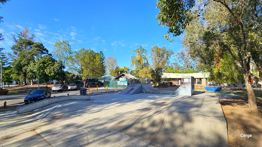Skate Park in Dayboro has a large open flat space in the middle with an angle ledge on the left and a flat launch ramp on one end. Further to the left are car park spaces separated by white lines. The perimeter of Dayboro Pool and Gym is surrounded by tall trees with a large canopy cover. Skate Park in Dayboro has a large open flat space in the middle with an angle ledge on the left and a flat launch ramp on one end. Further to the left are car park spaces separated by white lines. The perimeter of Dayboro Pool and Gym is surrounded by tall trees with a large canopy cover.