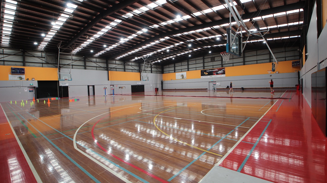 Gymnasium is divided into two courts. The first court is labeled as “Court 1” while the 2nd court is labeled “Court 2”. Separating the two courts is a net. Gymnasium is divided into two courts. The first court is labeled as “Court 1” while the 2nd court is labeled “Court 2”. Separating the two courts is a net.