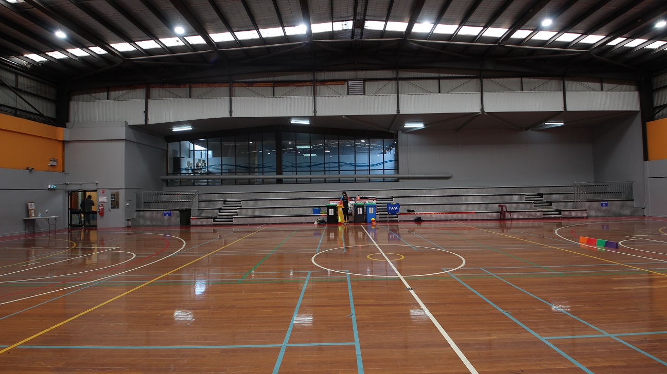 At the side of the two courts is a grey stadium with 4 steps that can accommodate at least 100 people. At the edge of the stadium is a metal railing that separates the audience from the players. At the side of the two courts is a grey stadium with 4 steps that can accommodate at least 100 people. At the edge of the stadium is a metal railing that separates the audience from the players.
