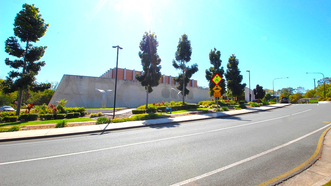 Another angle of the roadside at Gympie ARC. Immaculately manicured gardens and neatly arranged rows of trees grace the surroundings. Alongside these green features, numerous post lights provide illumination, casting a warm glow. Additionally, road signs are conspicuously positioned along the sidewalk, ensuring clear guidance for pedestrians and motorists alike. Another angle of the roadside at Gympie ARC. Immaculately manicured gardens and neatly arranged rows of trees grace the surroundings. Alongside these green features, numerous post lights provide illumination, casting a warm glow. Additionally, road signs are conspicuously positioned along the sidewalk, ensuring clear guidance for pedestrians and motorists alike.