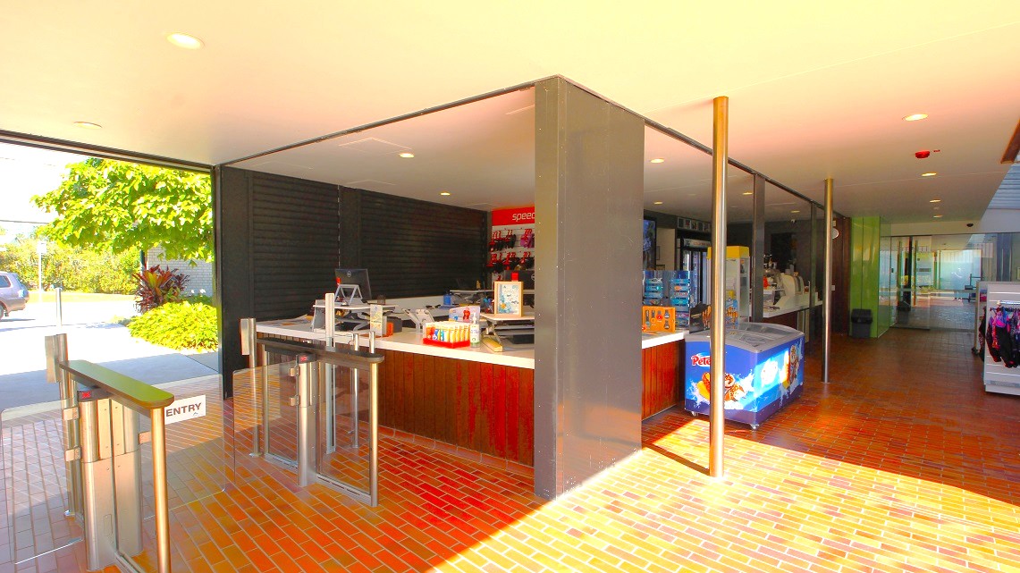 Another angle of the front entrance. Prominent brick floor tiles and metal grill doors near the reception area create a rustic-modern contrast. A wide, spacious right-side pathway enhances accessibility, while the presence of a visible batch freezer suggests a focus on food service or hospitality. Another angle of the front entrance. Prominent brick floor tiles and metal grill doors near the reception area create a rustic-modern contrast. A wide, spacious right-side pathway enhances accessibility, while the presence of a visible batch freezer suggests a focus on food service or hospitality.