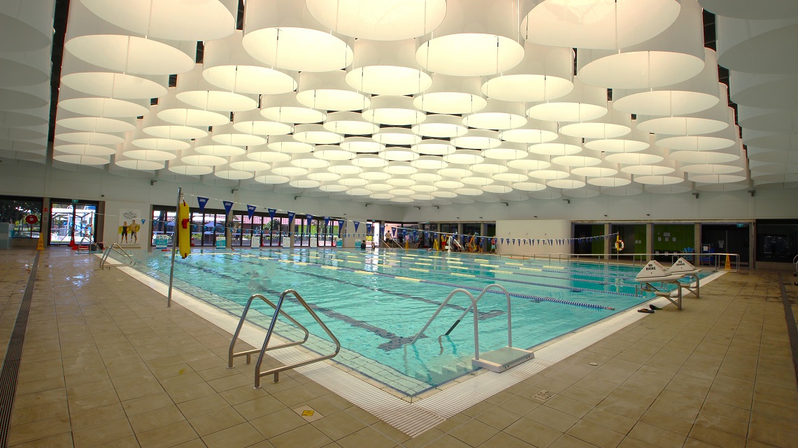 Another angle of the indoor heated pool. The step access to the pool is conveniently situated beside one of the safety pool railings, making it easily accessible for swimmers. The indoor pool itself is quite expansive, mirroring the spaciousness of the surrounding pathways, providing ample room for various aquatic activities. Another angle of the indoor heated pool. The step access to the pool is conveniently situated beside one of the safety pool railings, making it easily accessible for swimmers. The indoor pool itself is quite expansive, mirroring the spaciousness of the surrounding pathways, providing ample room for various aquatic activities.