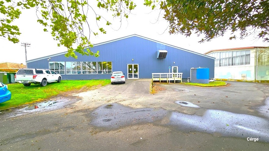 A closer view of the side angle of Huntly Aquatic Centre, which has a large cemented space and a landscaped area.. There are three cars outside, with two cars close to the building, while the blue car is near Wight Street. An inclined ramp leads to the glass entrance doors to the right is a small space with white-painted handrails. The glass windows reflect the natural surroundings of the centre. To the right is a large white building with glass windows near the roof. A closer view of the side angle of Huntly Aquatic Centre, which has a large cemented space and a landscaped area.. There are three cars outside, with two cars close to the building, while the blue car is near Wight Street. An inclined ramp leads to the glass entrance doors to the right is a small space with white-painted handrails. The glass windows reflect the natural surroundings of the centre. To the right is a large white building with glass windows near the roof.