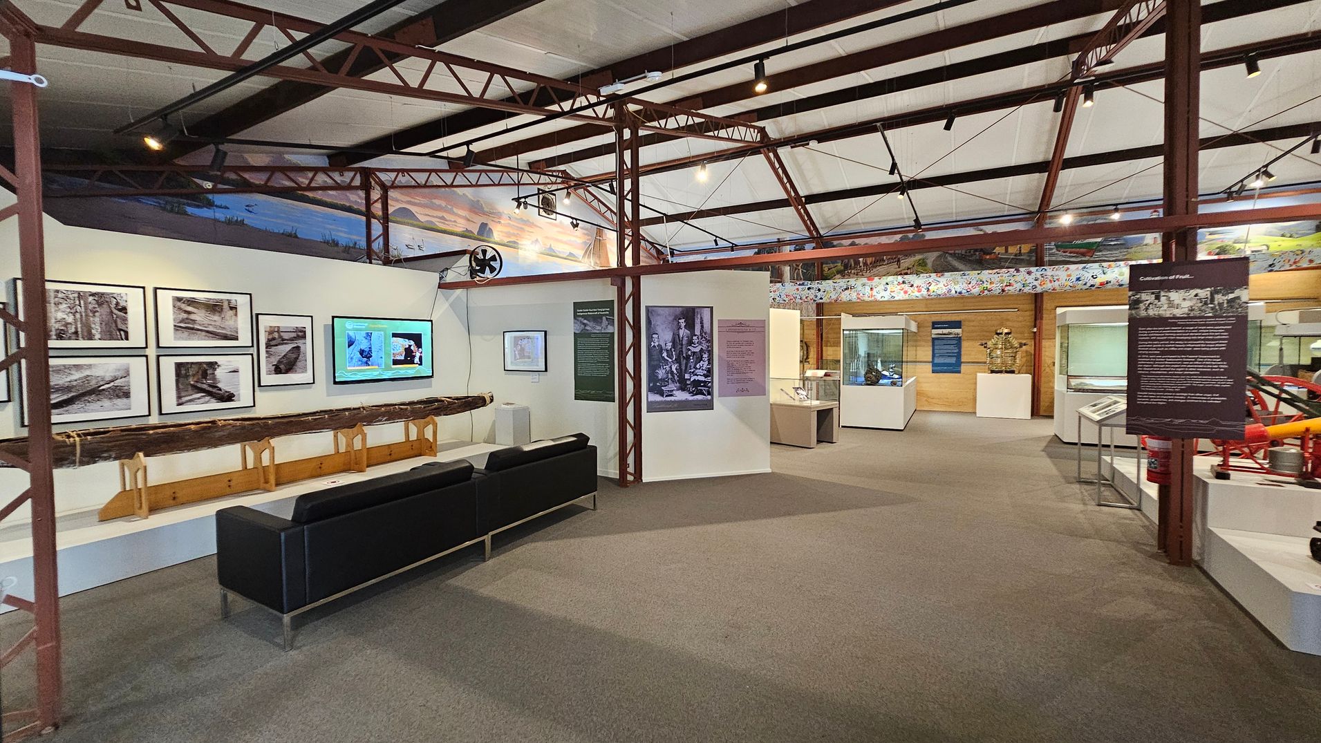 Entrance to a museum exhibit with glass doors. On the left, there are signs prohibiting eating, drinking, and touching displays. Inside, the exhibit features various displays and information panels. On the right, a panel about William Landsborough, an explorer, is visible, along with a stand holding brochures. The floor is carpeted, and the ceiling has exposed beams and lighting. Red metal pipes are visible on the left side of the entrance. Entrance to a museum exhibit with glass doors. On the left, there are signs prohibiting eating, drinking, and touching displays. Inside, the exhibit features various displays and information panels. On the right, a panel about William Landsborough, an explorer, is visible, along with a stand holding brochures. The floor is carpeted, and the ceiling has exposed beams and lighting. Red metal pipes are visible on the left side of the entrance.