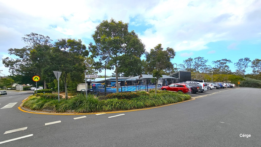 Arrival at Mudgeeraba Aquatic Centre is through the sloping road off School Street. The entire property is nestled between bushes and trees with a great leaf canopy cover. Right before the parking lot is a zebra crossing with a circular orange and yellow road sign with legs in the middle. There is a fence covering the property but is visible up the parking. Arrival at Mudgeeraba Aquatic Centre is through the sloping road off School Street. The entire property is nestled between bushes and trees with a great leaf canopy cover. Right before the parking lot is a zebra crossing with a circular orange and yellow road sign with legs in the middle. There is a fence covering the property but is visible up the parking.