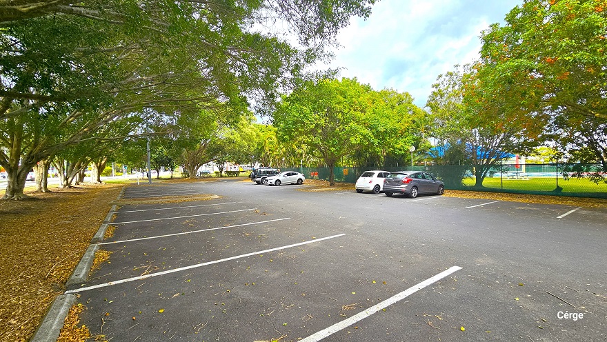 Road adjacent to a local school near Murrumba Downs Swimming Pool and leading to the carpark area. Line on the side of the road is a grey wooden boardwalk guide. The dedicated carpark is heavily shaded by Moreton Bay Fig trees and Golden Palms. Tall lamp posts can be found around the area. Road adjacent to a local school near Murrumba Downs Swimming Pool and leading to the carpark area. Line on the side of the road is a grey wooden boardwalk guide. The dedicated carpark is heavily shaded by Moreton Bay Fig trees and Golden Palms. Tall lamp posts can be found around the area.