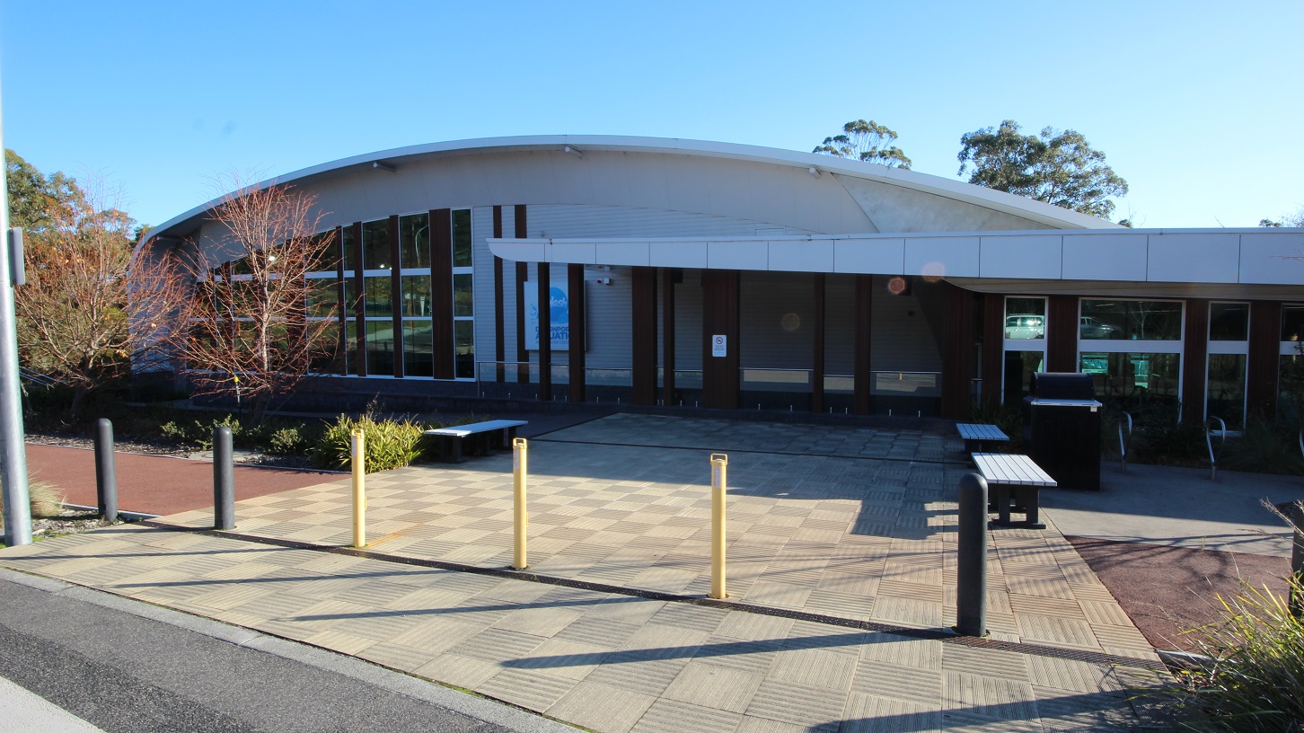 There are designated accessible car spaces located near the entrance of Splash Devonport. These spaces are marked with yellow bollards and yellow lines to indicate that they are reserved for persons with disabilities. Surrounding the car spaces is a pathway to move around the whole venue. On the curbs of the parking area is a plant box with a tree, while others have shrubs with moderate leaf length. There are designated accessible car spaces located near the entrance of Splash Devonport. These spaces are marked with yellow bollards and yellow lines to indicate that they are reserved for persons with disabilities. Surrounding the car spaces is a pathway to move around the whole venue. On the curbs of the parking area is a plant box with a tree, while others have shrubs with moderate leaf length.