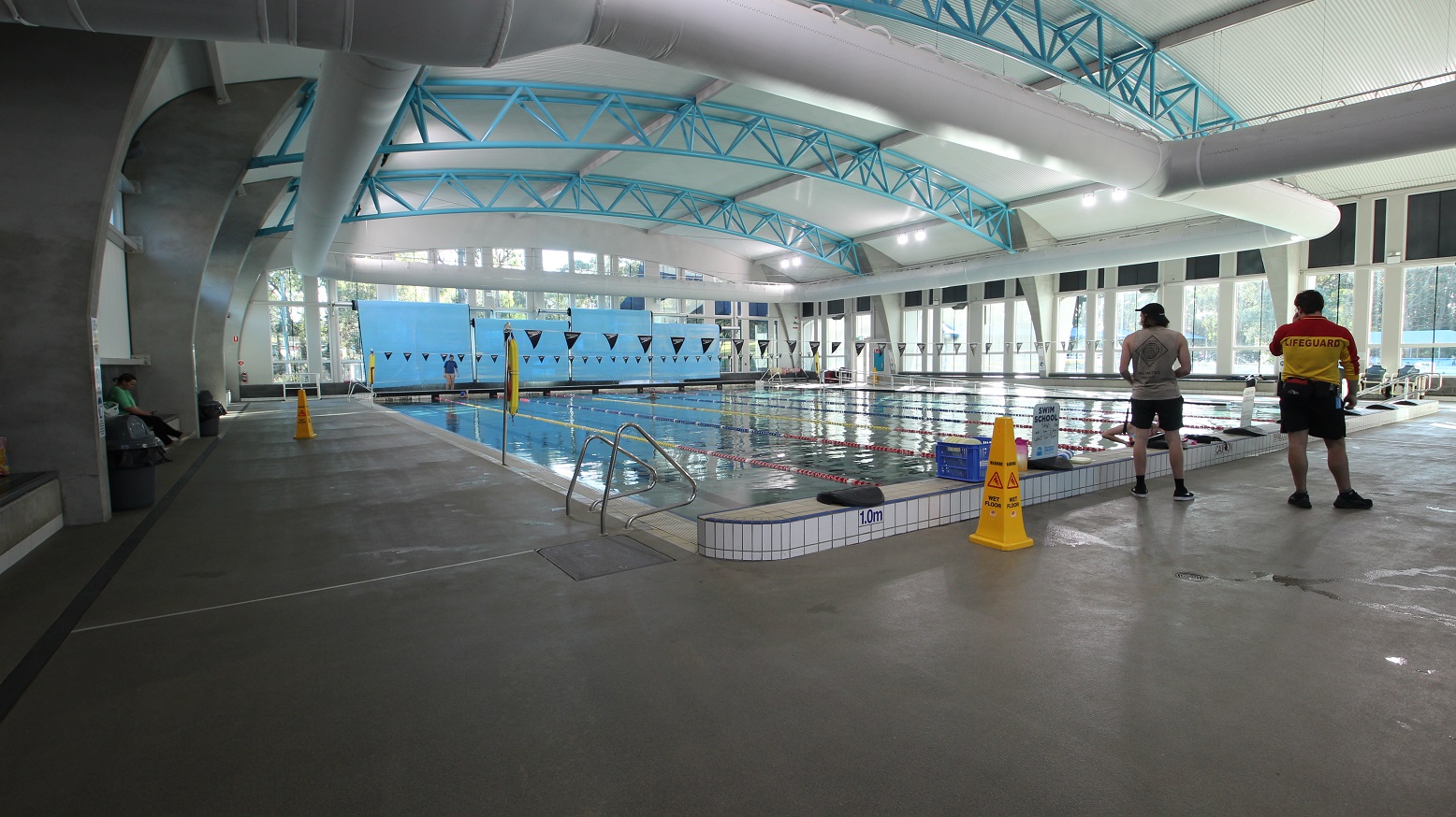 In 8 Lane 25m Pool is a hanging of small triangular flags placed horizontally to the pool area. The pool lanes are separated by red and yellow floating lane ropes, while the others are separated by red and blue lane ropes. Left of the pool is the stair, while on the right is the entrance ramp with a metal handrail. The starting point is an elevated section with different depth marks on each lane. In 8 Lane 25m Pool is a hanging of small triangular flags placed horizontally to the pool area. The pool lanes are separated by red and yellow floating lane ropes, while the others are separated by red and blue lane ropes. Left of the pool is the stair, while on the right is the entrance ramp with a metal handrail. The starting point is an elevated section with different depth marks on each lane.