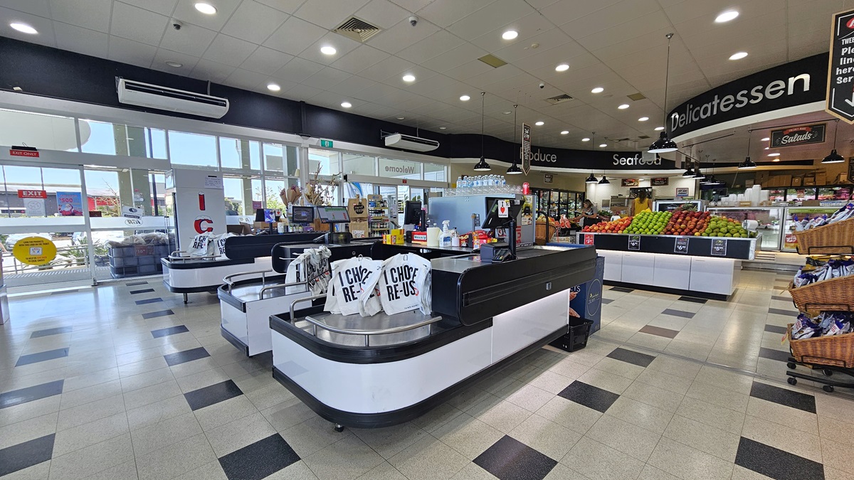 A closer look at the checkout counters. Three checkout counters with the same colors of black and white have reusable bags sitting on top of each of them. Two big air conditioners are visible on top of a wall, near the entrance. On top of the three checkout counters, various products are apparent. Several CCTVs are prominently placed on top of the ceiling. A closer look at the checkout counters. Three checkout counters with the same colors of black and white have reusable bags sitting on top of each of them. Two big air conditioners are visible on top of a wall, near the entrance. On top of the three checkout counters, various products are apparent. Several CCTVs are prominently placed on top of the ceiling.