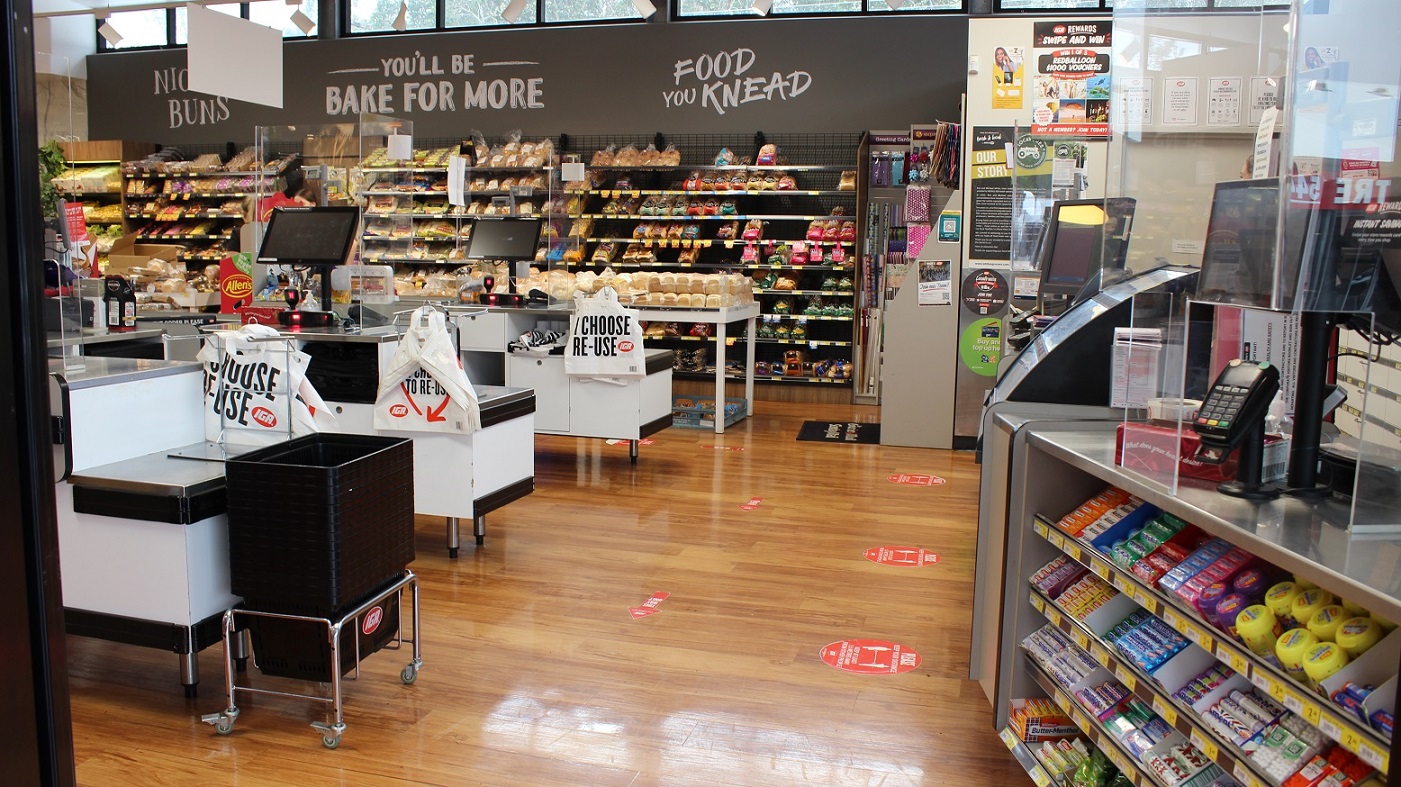 This payment section of the grocery store offers three available white counters. There is a selection of bread items on display to the right with signage above stating “Night Buns”, “Bake for More” and “Food You Knead”. The plastic shopping bags are also available in each counter that has a reminder to the customer: “I choose. Re-use”. Two more counters are available at the other side of this section with a range of gum and lollies on display. This payment section of the grocery store offers three available white counters. There is a selection of bread items on display to the right with signage above stating “Night Buns”, “Bake for More” and “Food You Knead”. The plastic shopping bags are also available in each counter that has a reminder to the customer: “I choose. Re-use”. Two more counters are available at the other side of this section with a range of gum and lollies on display.