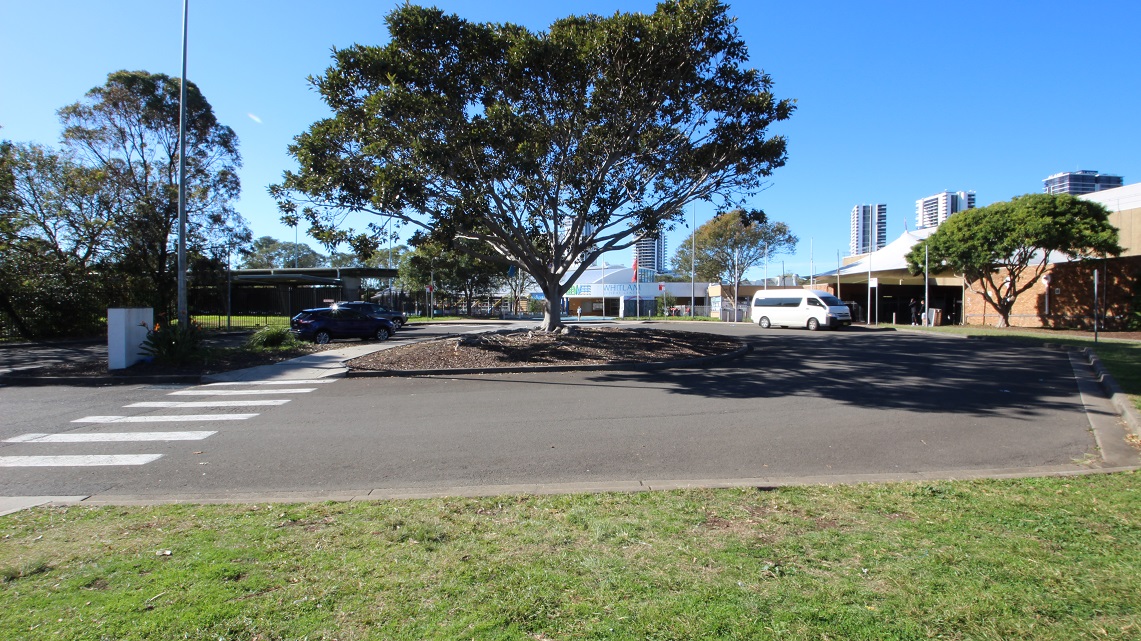 A white HI-ACE van is parked in one of the accessible car parks at Whitlam Leisure Centre, as marked by the accessible parking sign painted in blue and white. On its left side is an accessible parking sign only for persons with a mobility disability and an arrow pointing in the direction of the van. Two yellow bollards are erected in the space connected to the pathway leading to a pedestrian lane. A white HI-ACE van is parked in one of the accessible car parks at Whitlam Leisure Centre, as marked by the accessible parking sign painted in blue and white. On its left side is an accessible parking sign only for persons with a mobility disability and an arrow pointing in the direction of the van. Two yellow bollards are erected in the space connected to the pathway leading to a pedestrian lane.