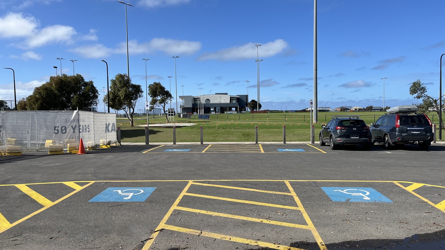 View from disabled carparks towards the oval, grant pavillion and path to access Wurdi Baierr stadium. Construction to the left, Council offices to the right. Image includes view of highjump course.